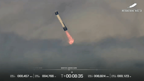 a large white-and-blue rocket fires its engines as it descends through clouds
