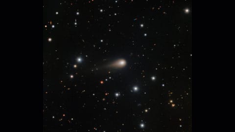 A streak of white shows interstellar comet 3I/ATLAS in the center of a starry night sky