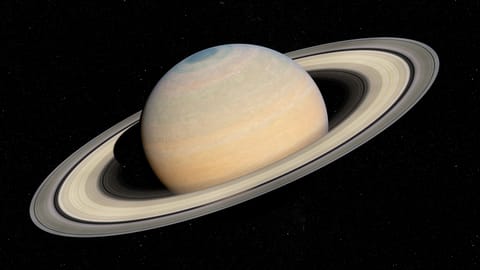 close up view of saturn with sandy colored rings.