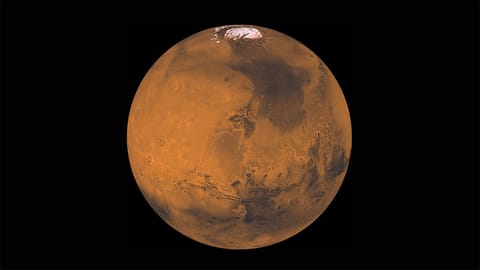spacecraft photo of mars in deep space, showing ice caps at its north pole