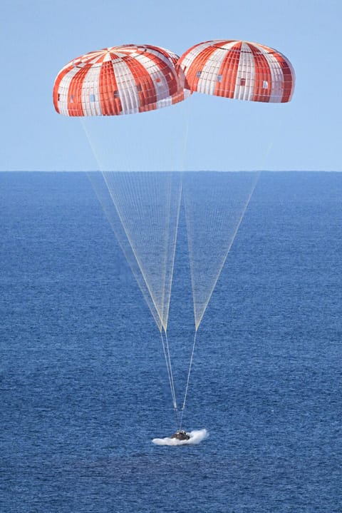 Parachutes set the Orion capsule down safely in the Pacific Ocean after its trip to the moon during the Artemis II mission