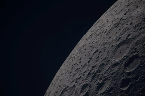 (April 6, 2026) – Poynting crater and Keeler crater are visible side by side in the lower right portion of this image of the Moon’s far side highlands. Poynting, positioned above, is a large impact crater with a well-defined rim and relatively smooth interior, indicative of material that has settled following the initial impact. Just below it, Keeler crater appears slightly smaller, with a sharply outlined rim and a more textured interior shaped by subsequent impacts and ejecta. Both features li