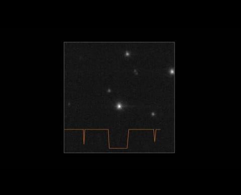 A black square with a lighter grey square inside it with a jagged orange line running across its base