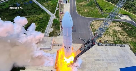 Insta360's Bold Rocket Launch Filmed with Advanced Cameras Takes Aim at DJI's Market Position A rocket launches from a pad with bright orange flames, white smoke, and a visible service tower.