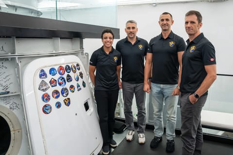 jsc2026e406103 The four members of the SpaceX Crew-13 mission pose for a portrait next to the Dragon spacecaft mockup after completing a pre‑flight training session at SpaceX headquarters in Hawthorne, California. (Courtesy/SpaceX)