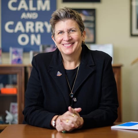 Julie Kramer White poses for a photo in her office