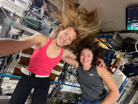 Expedition 74 Flight Engineers (from left) Sophie Adenot of ESA (European Space Agency) and Jessica Meir of NASA take a portrait together before beginning their exercise sessions. Afterward, Adenot worked out on the Advanced Resistive Exercise Device (ARED), which mimics free weights on Earth, while Meir jogged on the COLBERT treadmill. Both exercise devices are located inside the Tranquility module.