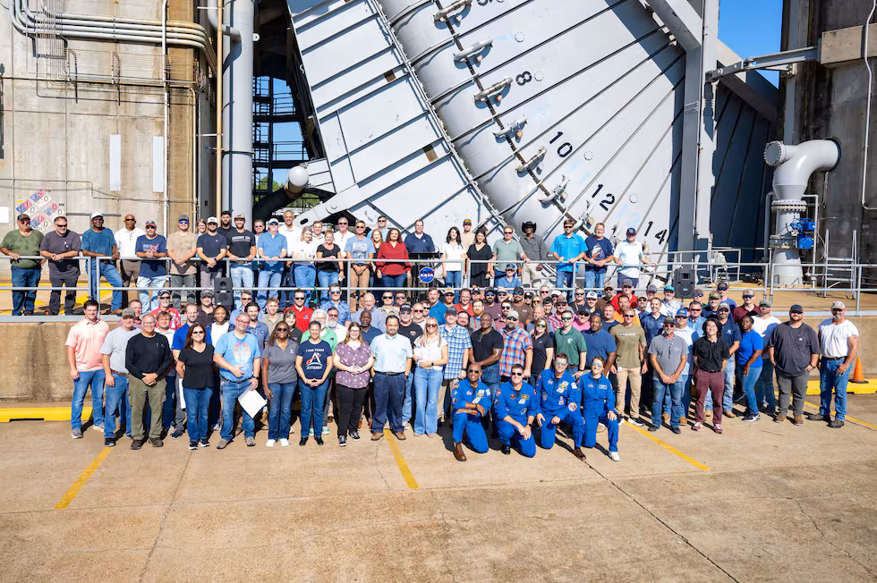 At the space center, the crew got to see the Fred Haise Test Stand, where RS-25 rockets were...